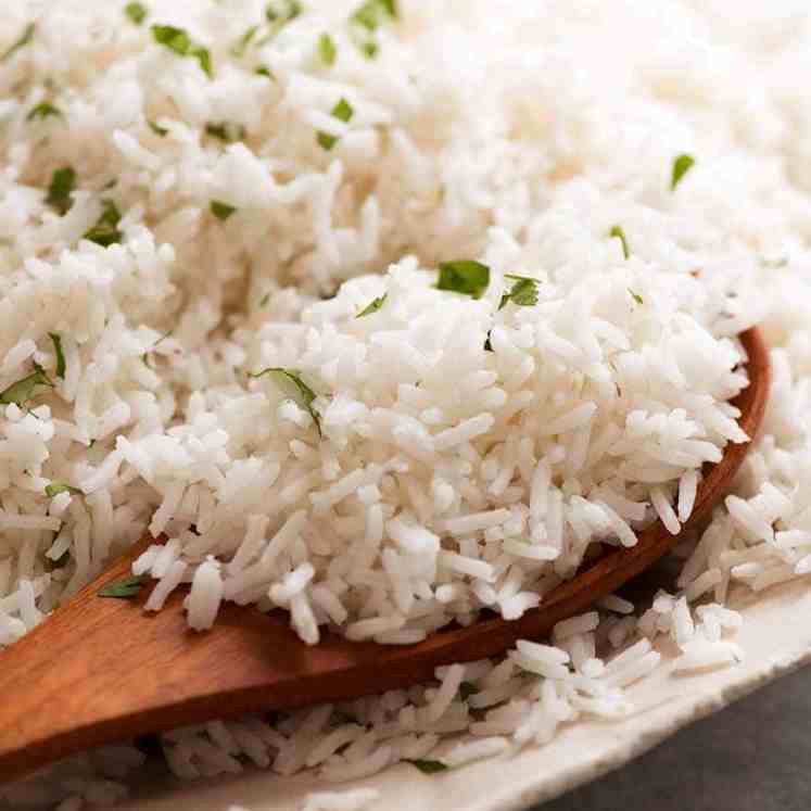 Close up of spoon scooping up fluffy Basmati Rice