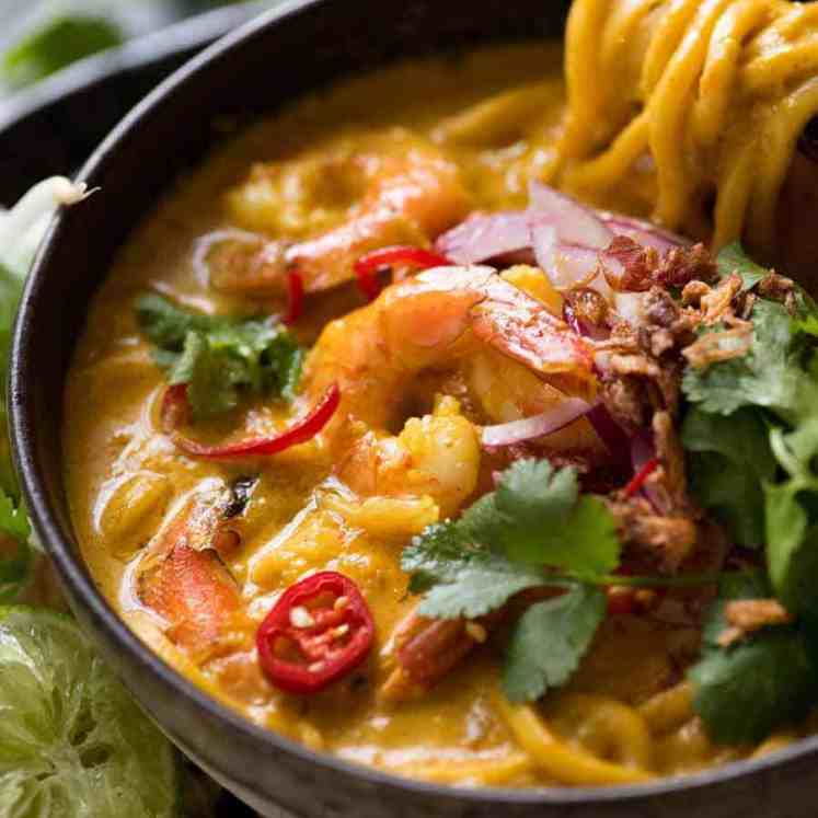 Thai Coconut Soup with Shrimp/Prawns and Noodles in a rustic bowl, ready to be eaten